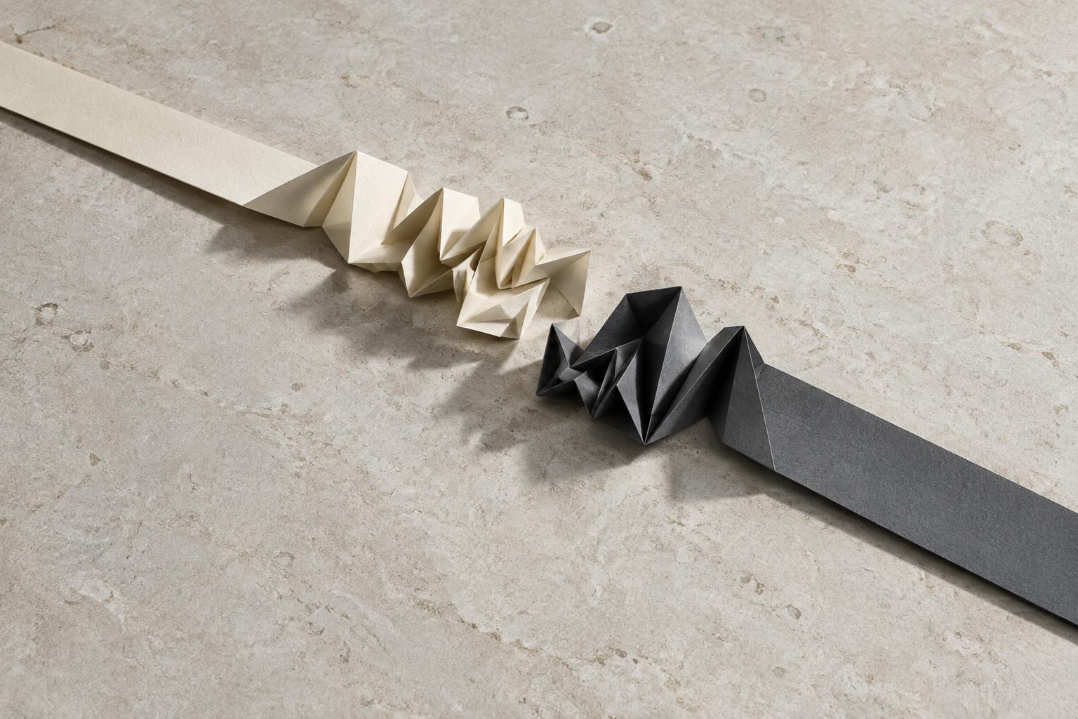 Two differently folded strips meet without becoming the same shape.